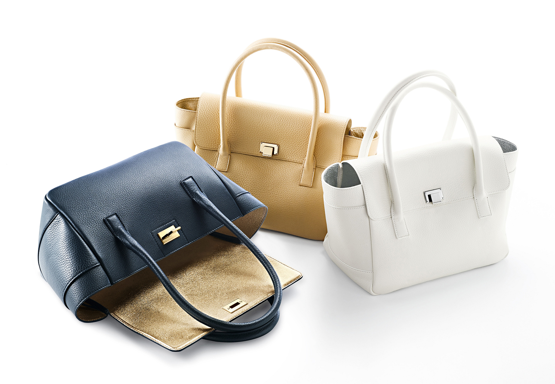 Tiffany & Co’s spring 2014 leather goods line offers handbags and wallets in a range of nautical blues, off-blacks, and striking reds, stylized to complement any Tiffany jewelry selection. Photos courtesy of Tiffany.