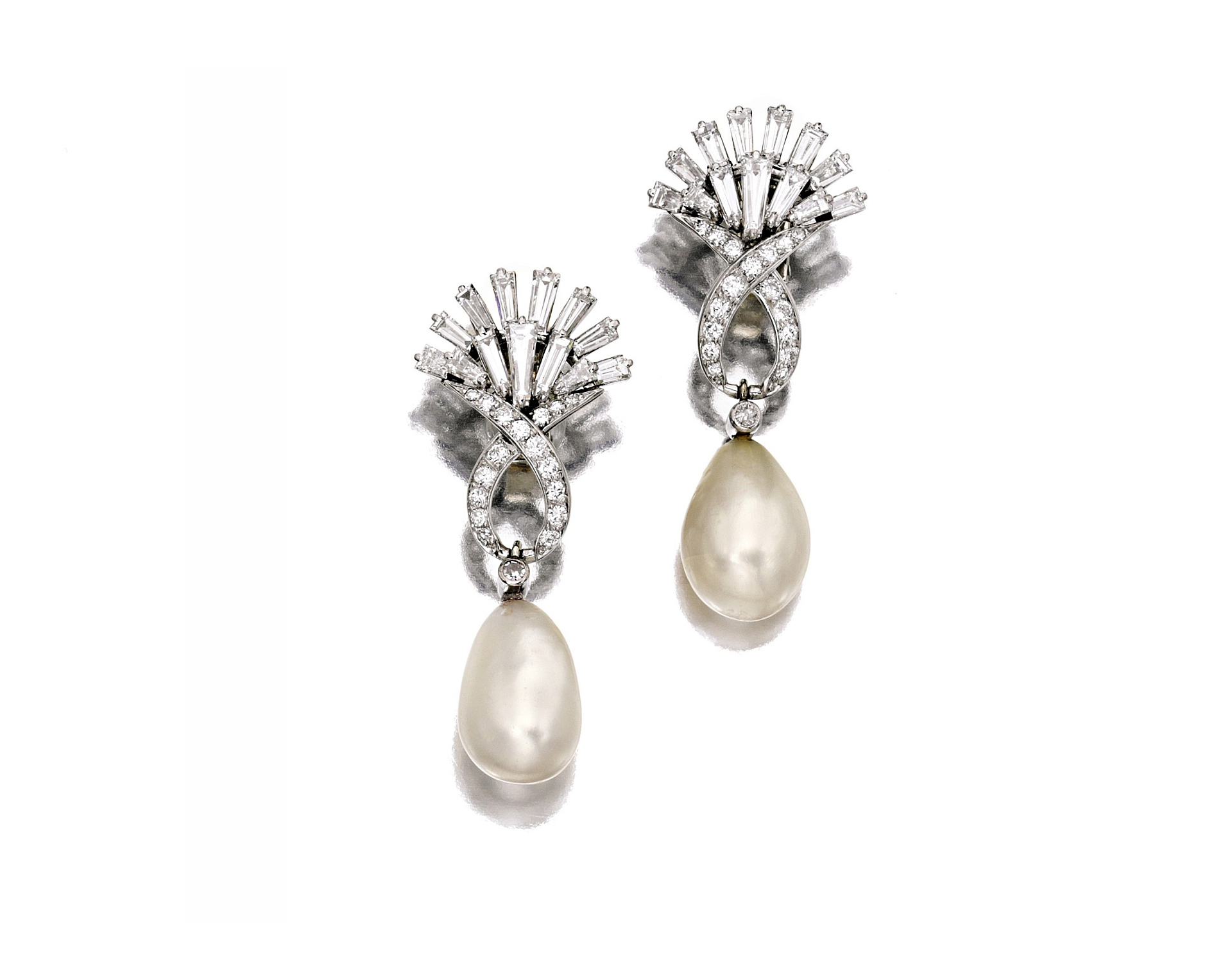 Estimated to draw in $15,000 to $20,000 are Boucheron's platinum, natural pearl, and diamond ear clips. Photo courtesy Sotheby's. 