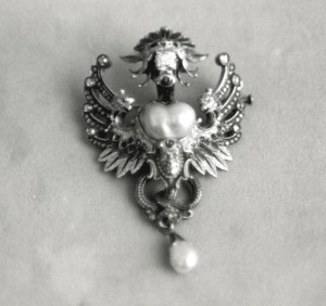 Lane's dragon brooch.