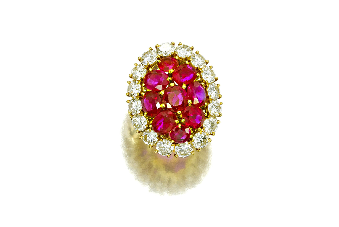 Mounted in 18 karat gold, the Burmese rubies of this Van Cleef & Arpels ring are framed by an estimated 4.9 carats of diamonds. Image courtesy of Bonhams.