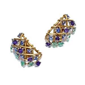 A pair of gem-set ear clips composed of amethyst, sapphire, and emeralds, mounted by Schlumberger, estimated at $7000 to $9000. Lauren Bacall wore these earrings when she accepted her award for Best Supporting Actress for her role in The Mirror Has Two Faces. 