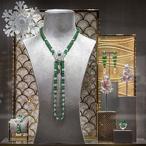 In one display case, a playful pair of brooches — which feature polar bears lovingly cradling their cubs who are set with pink pavé diamonds — sit amid a sea of emerald creations.